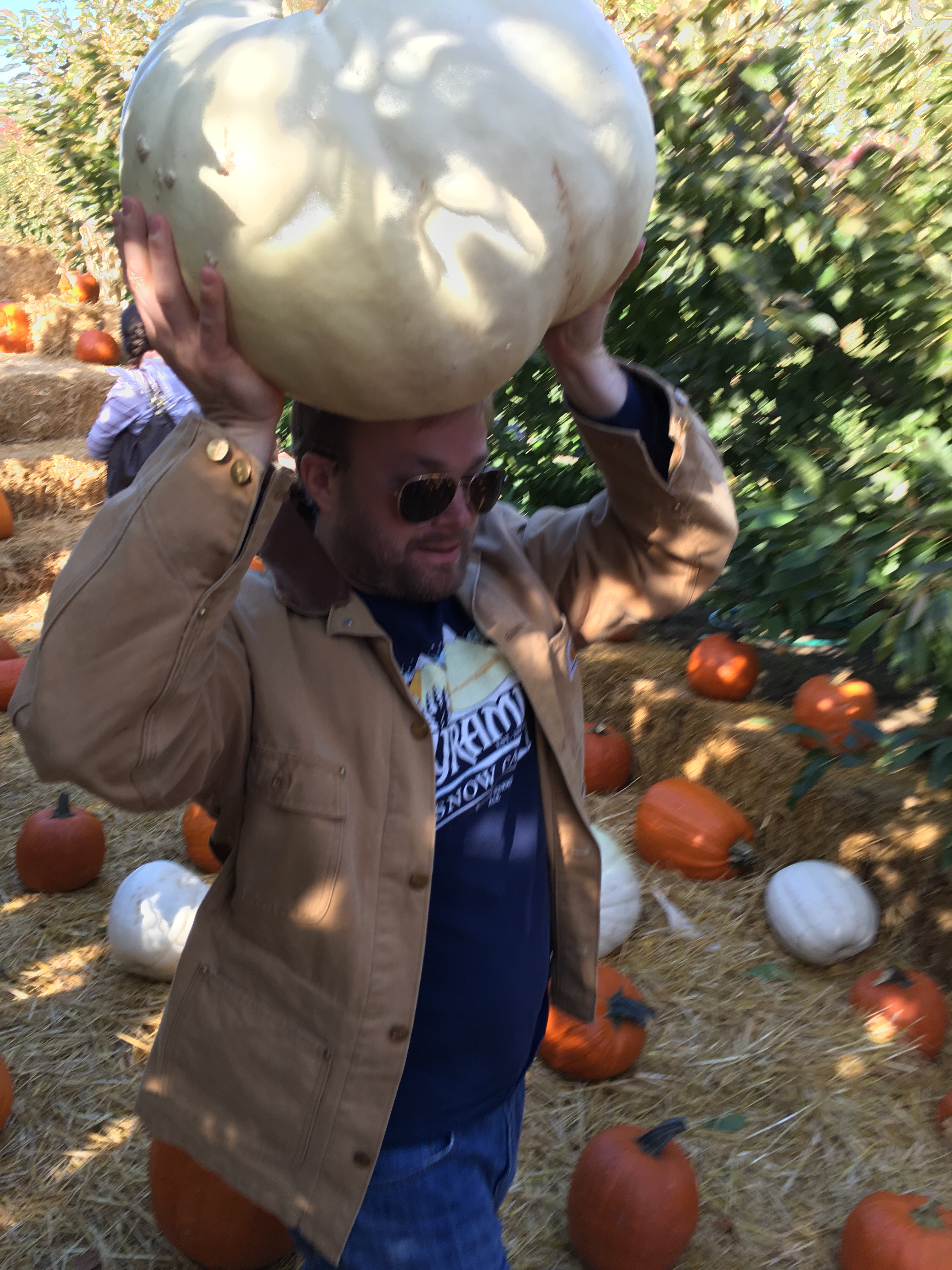 Hot hubby carrying the giant white pumpkin!